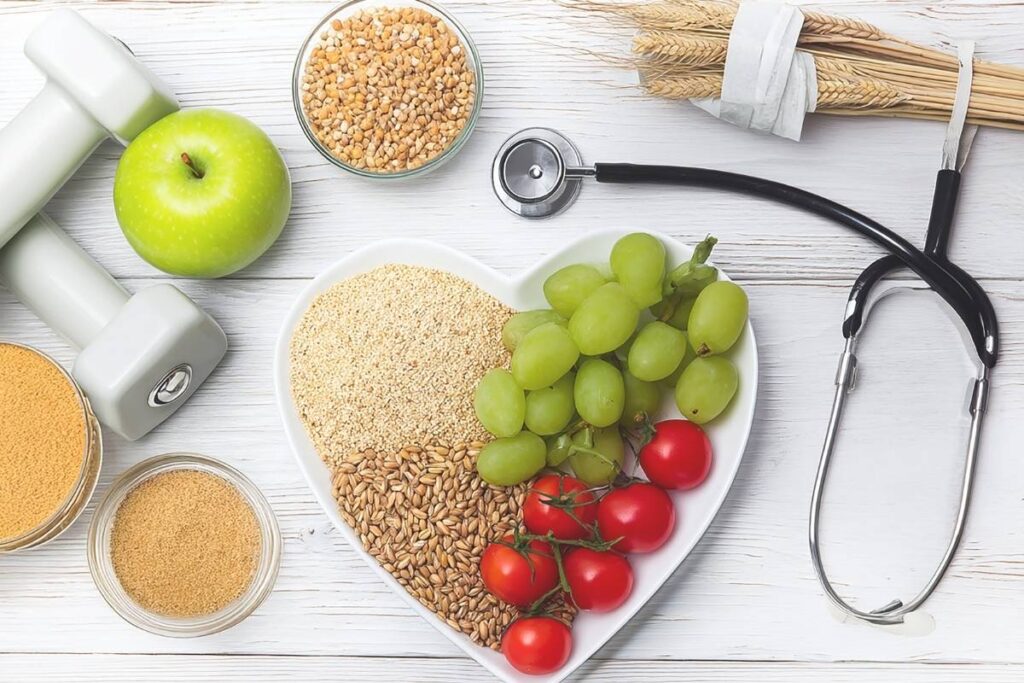 Heart-shaped bowl with seeds, grapes, and tomatoes.  Dumbbells and a stethoscope